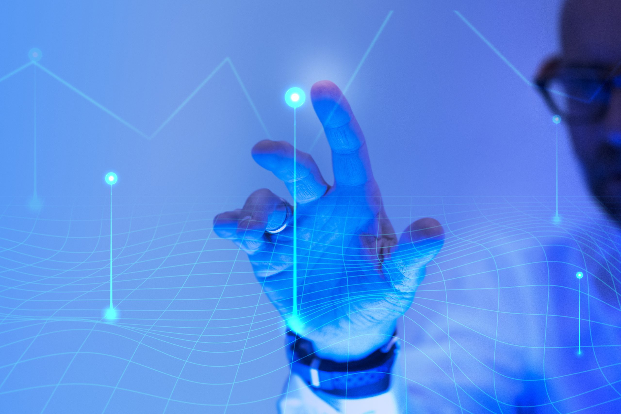 Man touching the futuristic blue screen